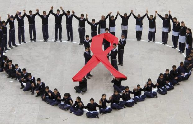Students make a formation in the shape of a heart and a red ribbon during a HIV/AIDS awareness campaign on Valentine's Day in the northern Indian city of Chandigarh
